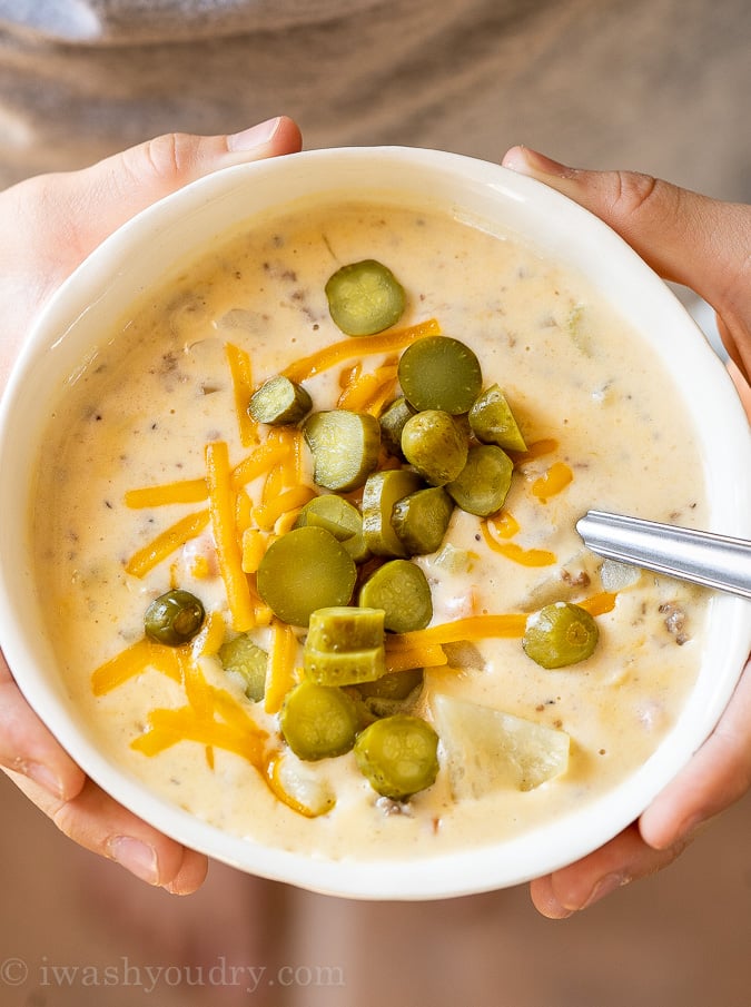 Bowl of Cheeseburger Soup being held in hands.