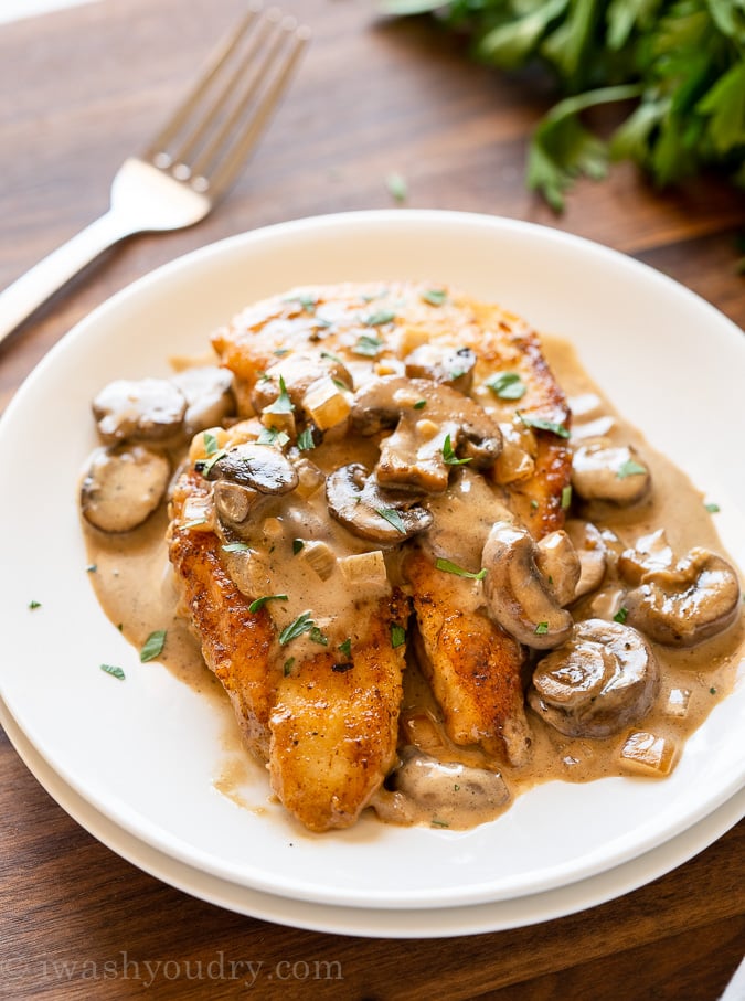 Plate of creamy chicken marsala with mushrooms and marsala sauce.