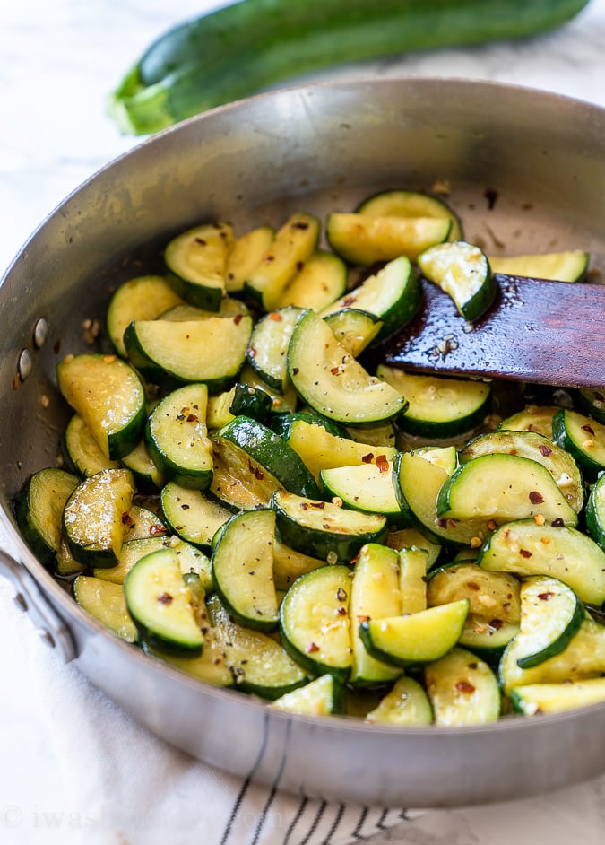 Sautéed Zucchini in a skillet with red pepper flakes.