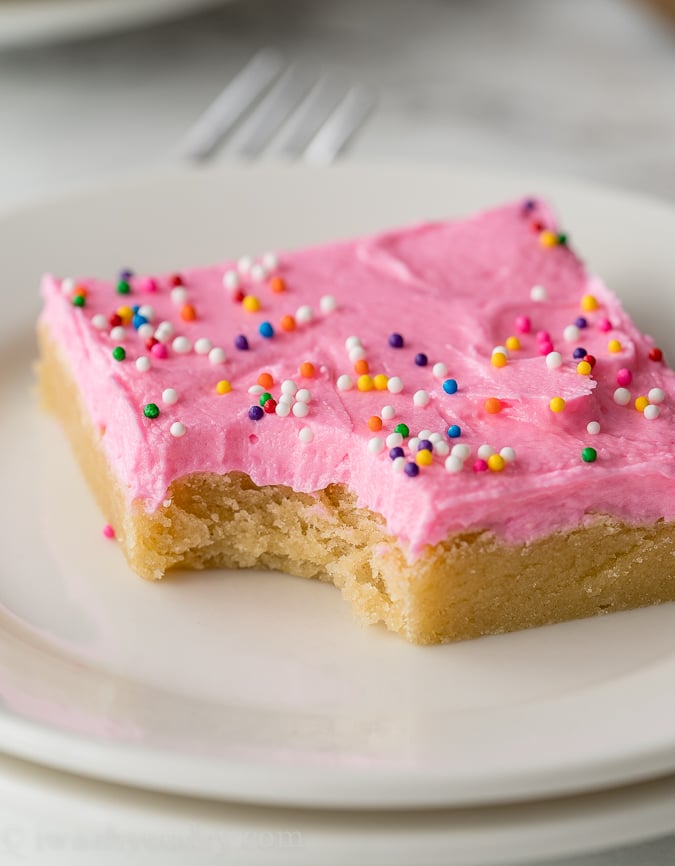 This Easy Sugar Cookie Recipe is topped with sugar cookie icing and sprinkles. Perfect for feeding a crowd!