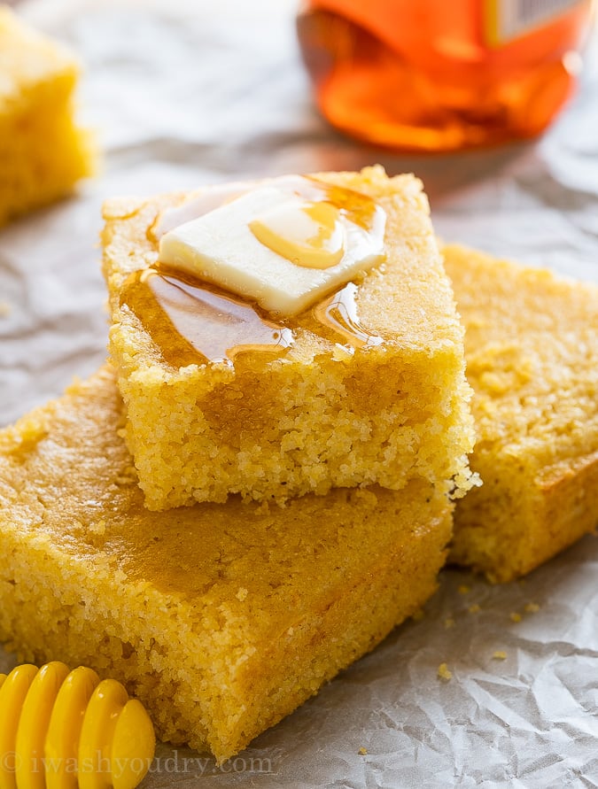 Cornbread slices with butter and honey on top