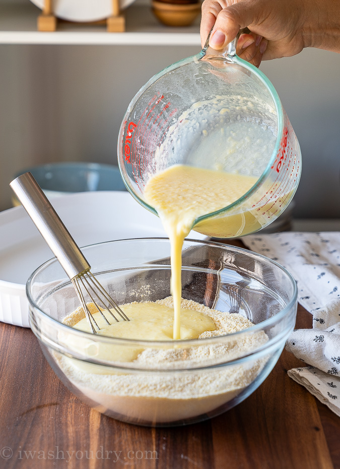 Pouring wet ingredients into dry ingredients