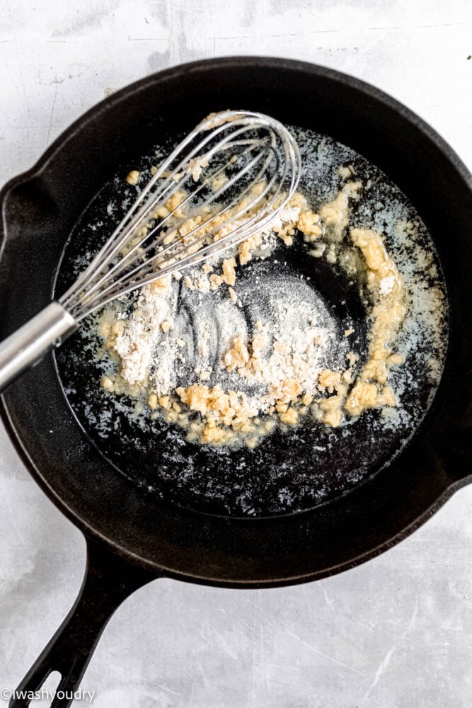 make a roux in a black skillet with a whisk.