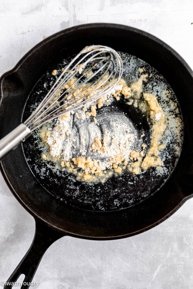 making a roux in black pan with whisk.