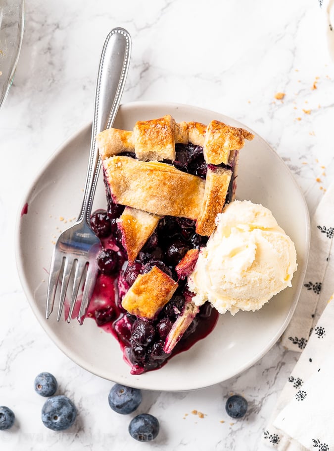 blueberry pie with vanilla ice cream on plate