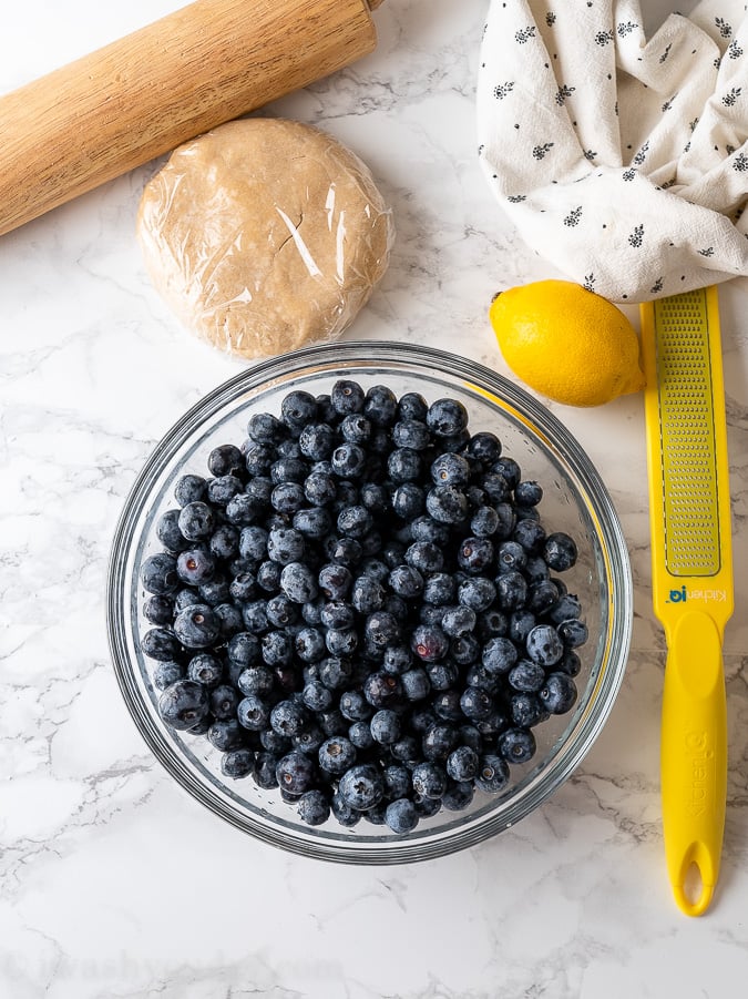 blueberries and lemon on cutting board