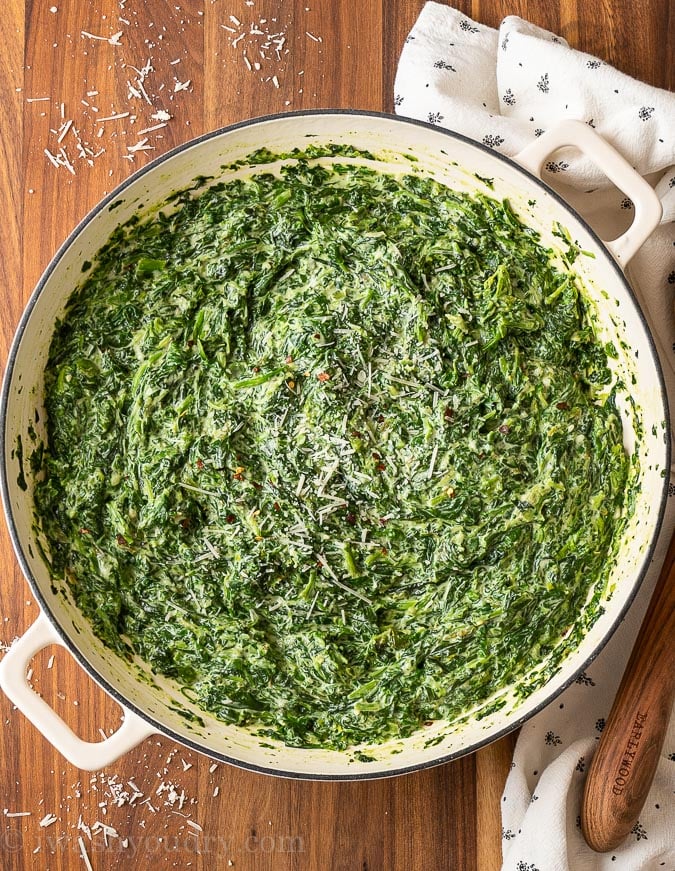 spinach in a pan on a wood table