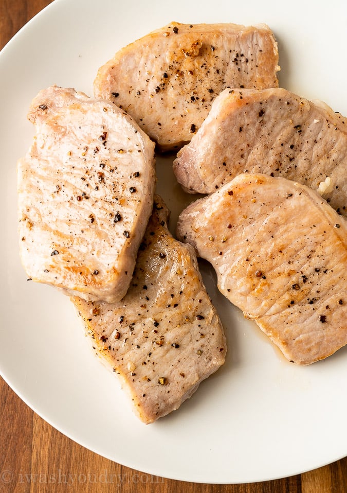 seared pork chops on white plate