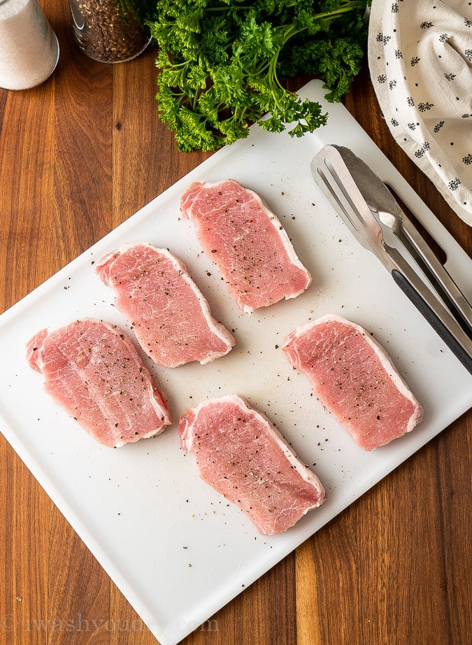 boneless pork chops on cutting board