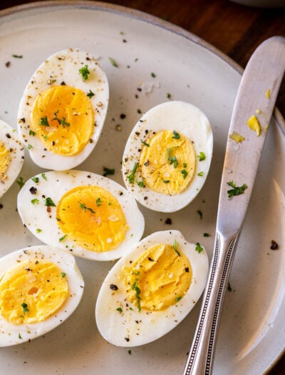 hard boiled eggs on plate with knife