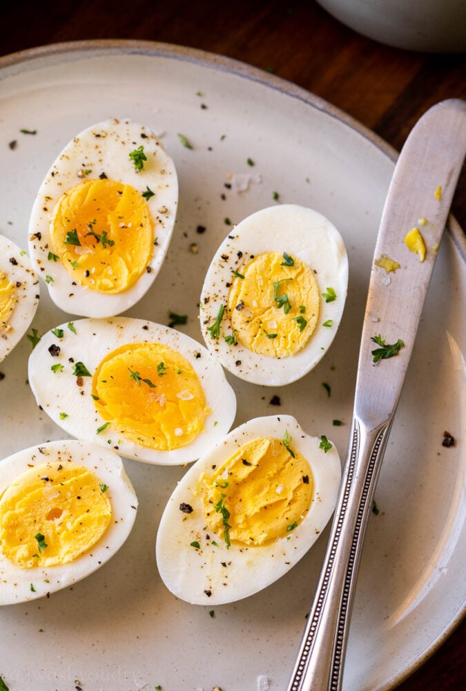 hard boiled eggs on plate with knife