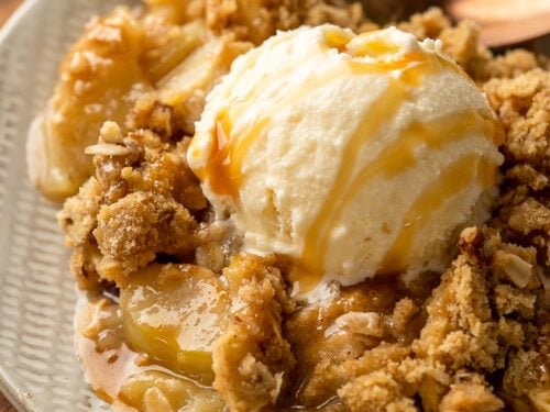 dessert on plate with apples and vanilla ice cream