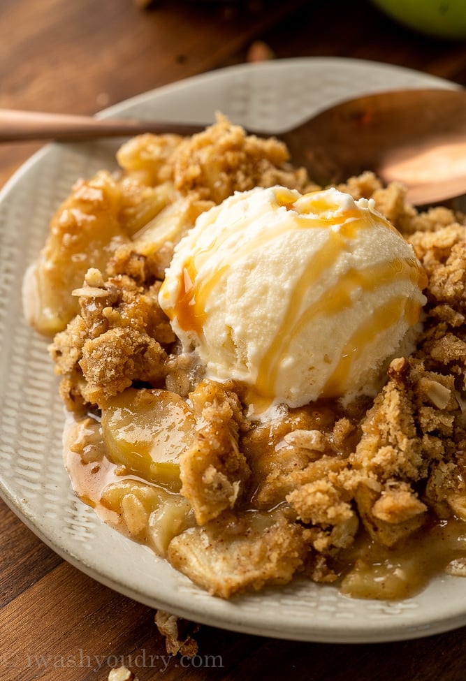 dessert on plate with apples and vanilla ice cream