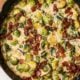 creamy brussels sprouts with bacon in a cast iron pan