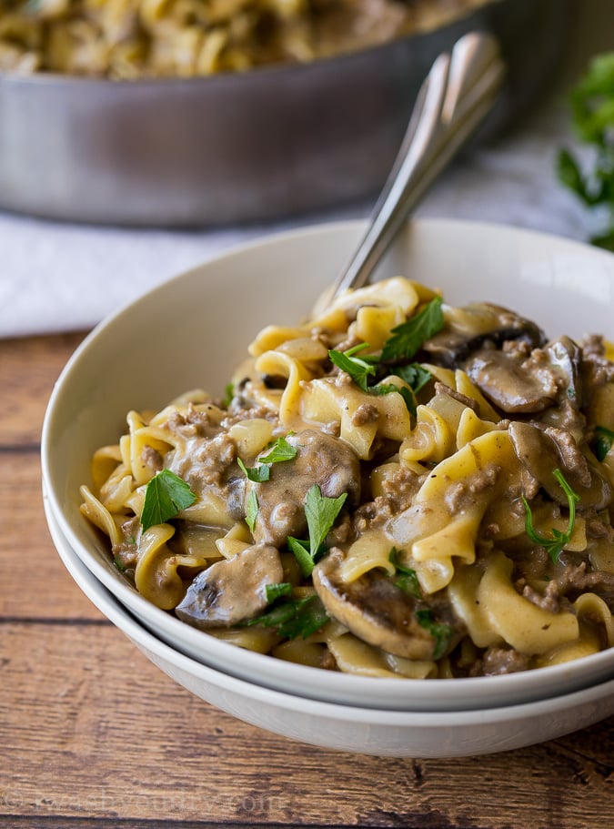 white bowl filled with creamy noodles and ground beef with mushrooms