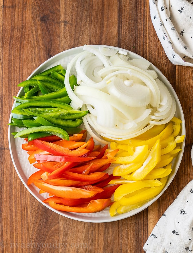 bell peppers and onions raw on plate