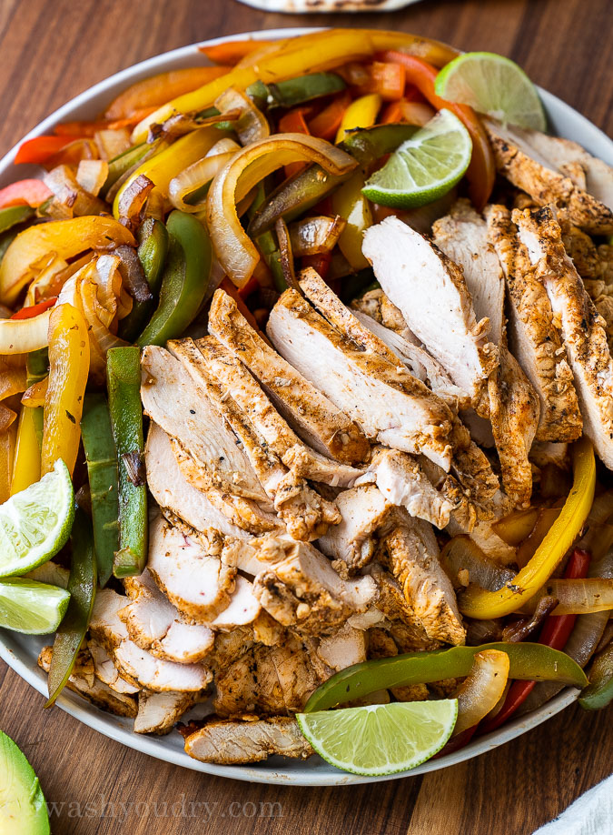 fajita chicken on plate with peppers and onions