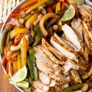 Plate with peppers, onions, limes and grilled chicken