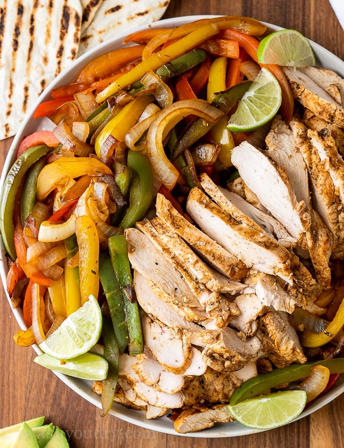 Plate with peppers, onions, limes and grilled chicken