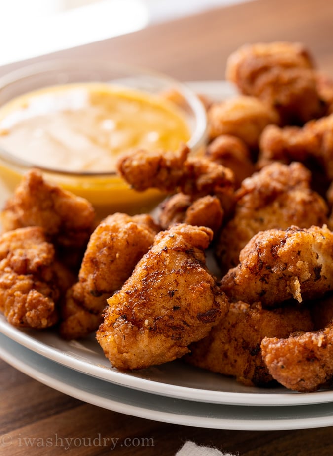 crispy chicken nuggets on a plate with dipping sauce