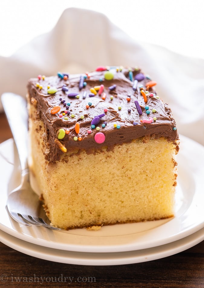 slice of vanilla cake with chocolate frosting