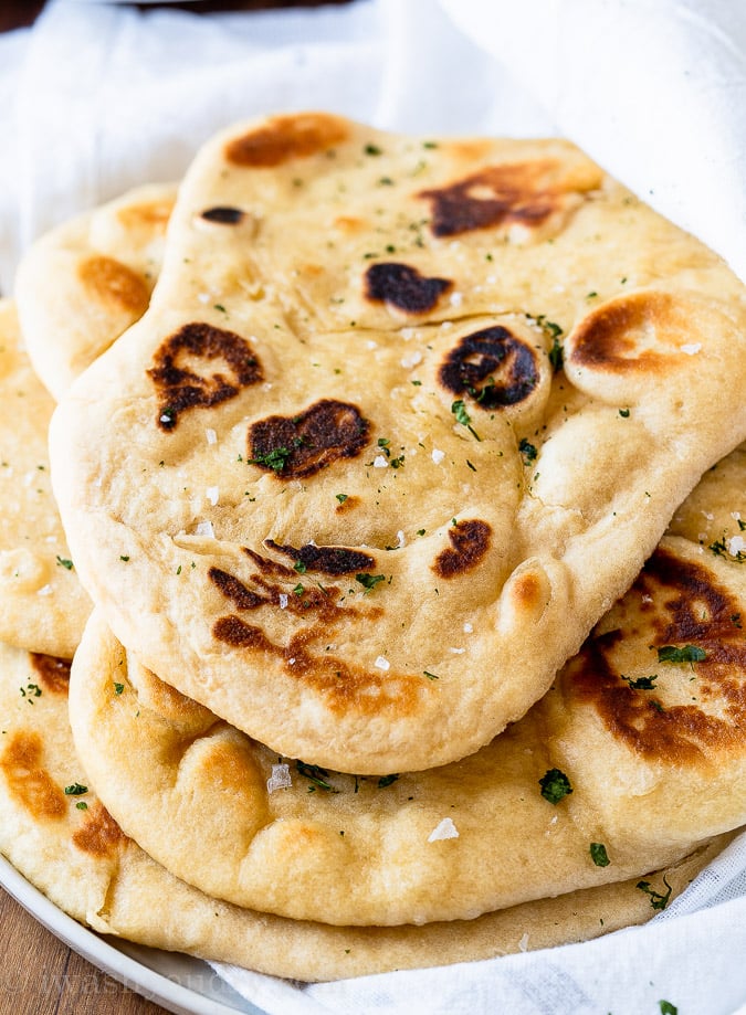 pile of soft naan bread on plate