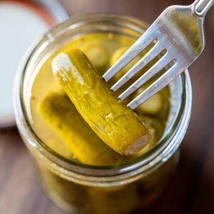 fresh dill pickles in jar with fork