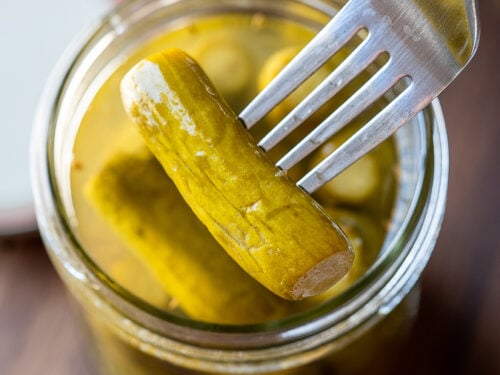 fresh dill pickles in jar with fork