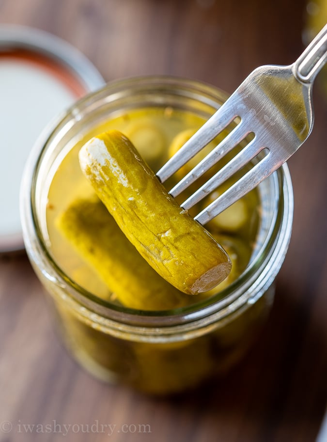 fresh dill pickles in jar with fork