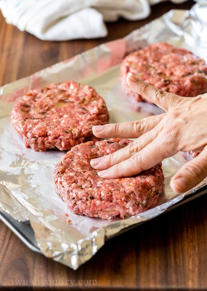 raw burgers getting ready to grill