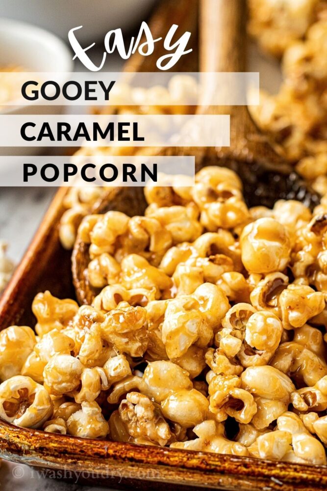 caramel corn in wooden spoon in metal pan with text overlay. 