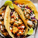 fish tacos on plate with limes