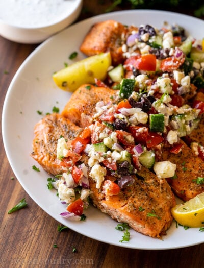 grilled salmon on white plate with greek salsa
