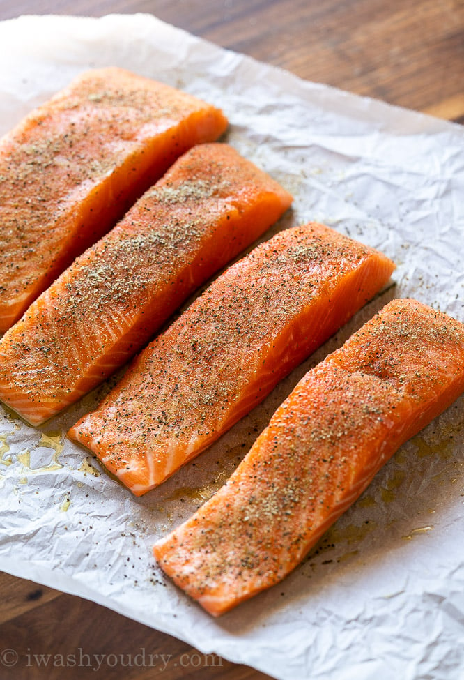 wild caught salmon filets on parchment paper