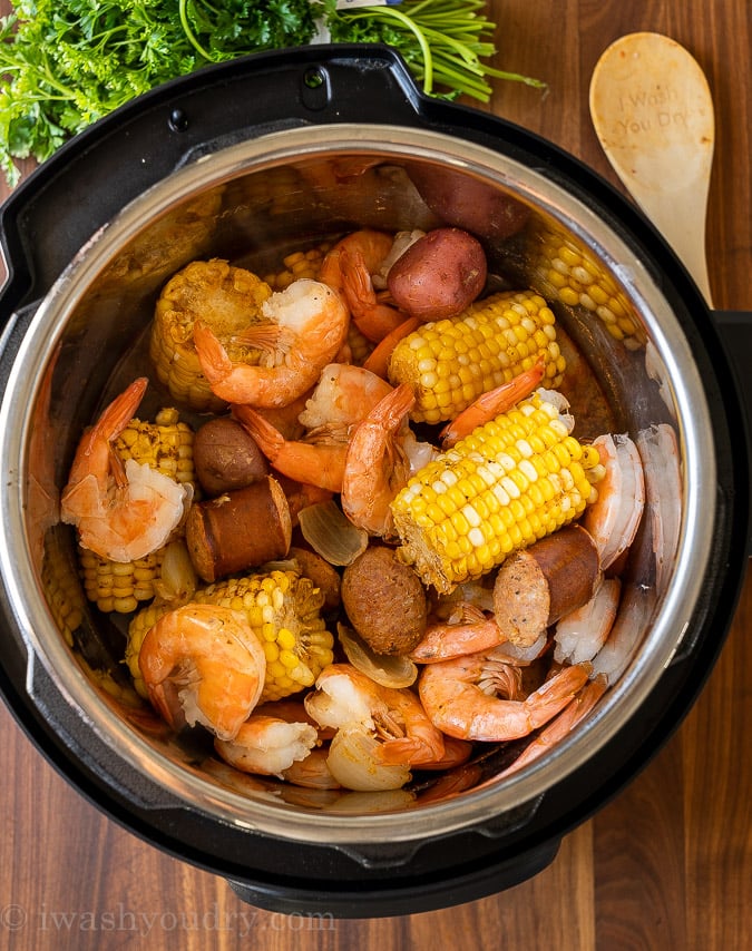 pressure cooker filled with shrimp, corn and potatoes