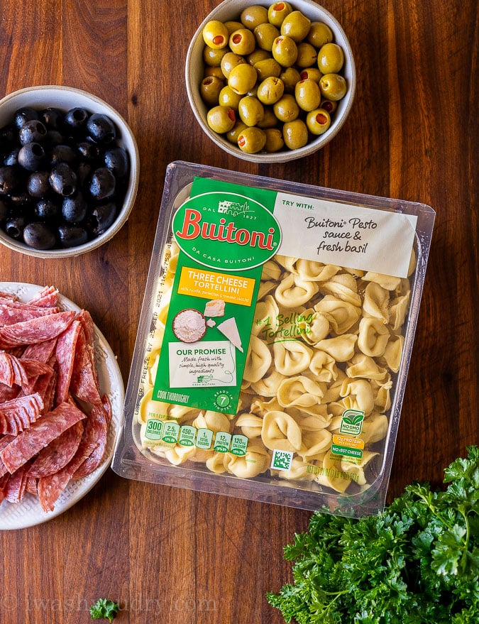 Ingredients for olive tortellini salad on table