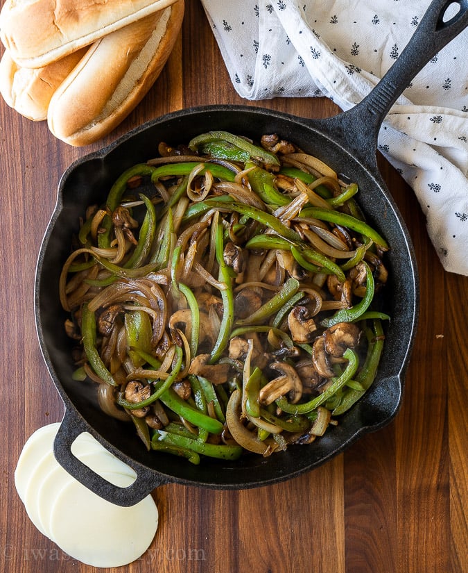 bell peppers and onions in cast iron pan