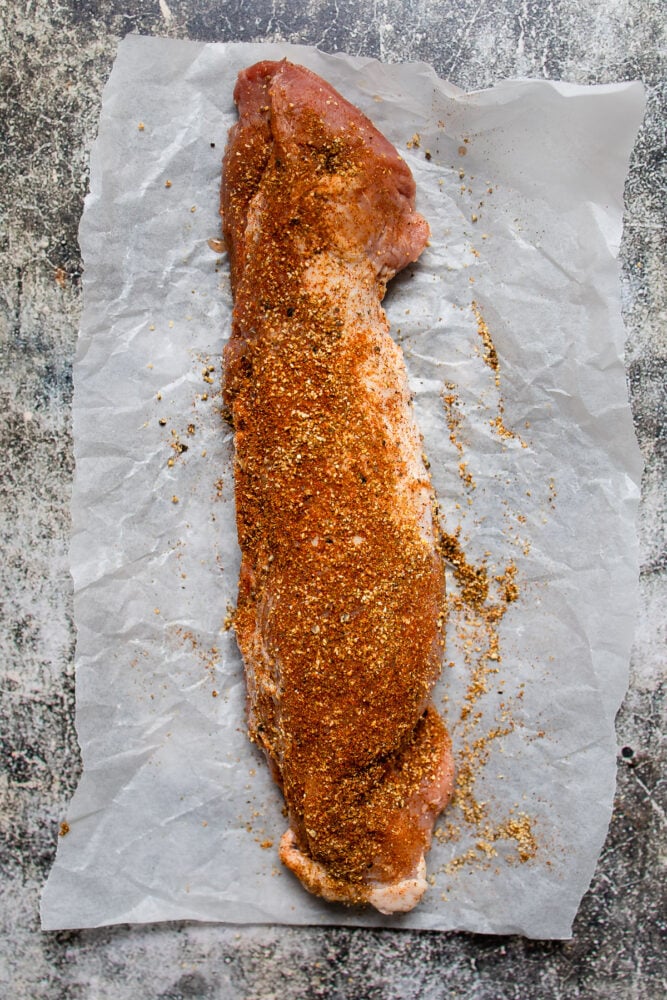 seasoned pork tenderloin on parchment paper