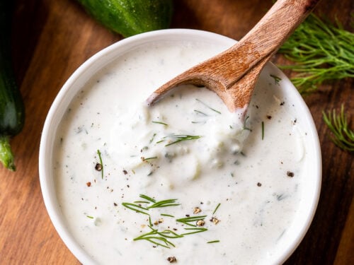 bowl of creamy greek tzatziki sauce with cucumbers and dill