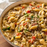 white pan full of ground beef and pasta shells in a creamy sauce
