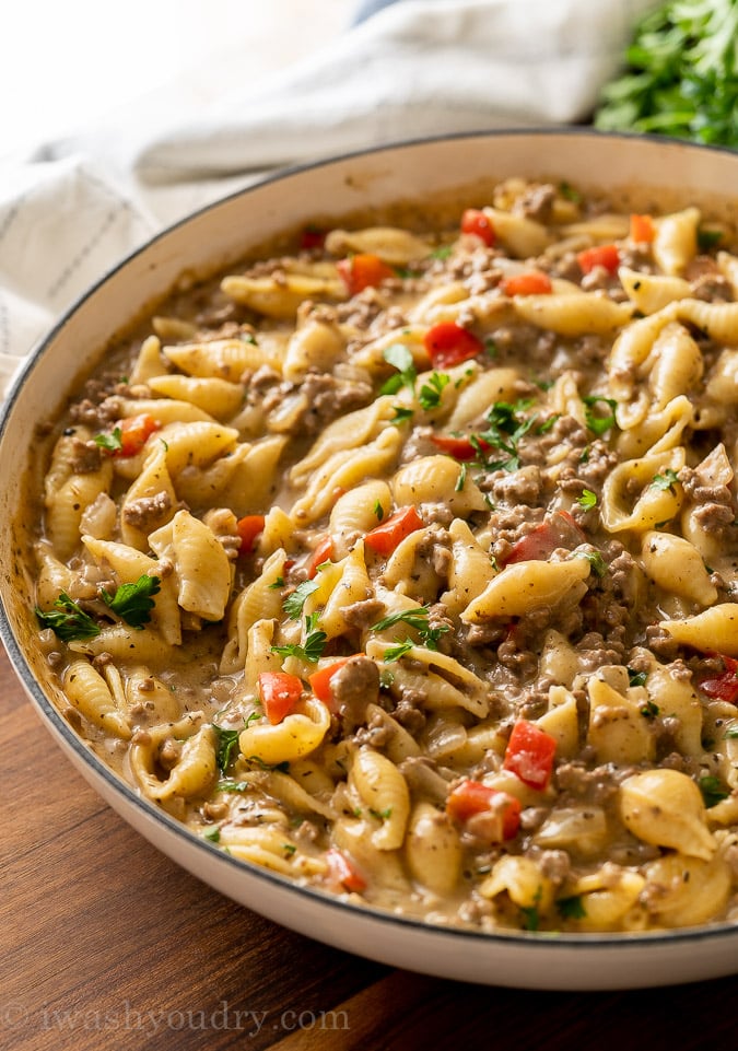 white pan full of ground beef and pasta shells in a creamy sauce