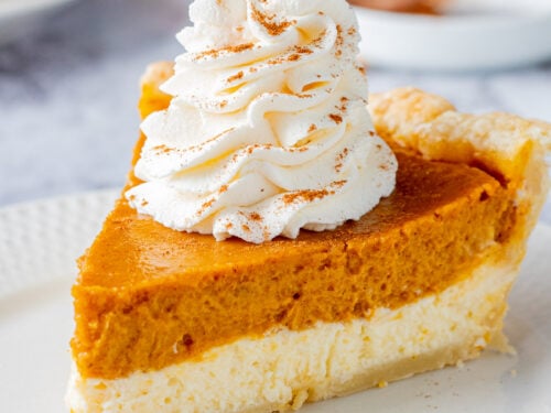 Slice of Pumpkin cheesecake pie on white plate.