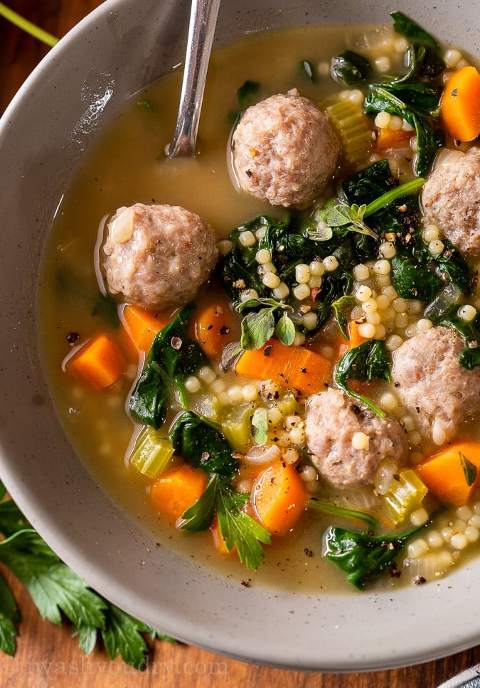 bowl of Italian wedding soup with tiny pasta and meatballs.