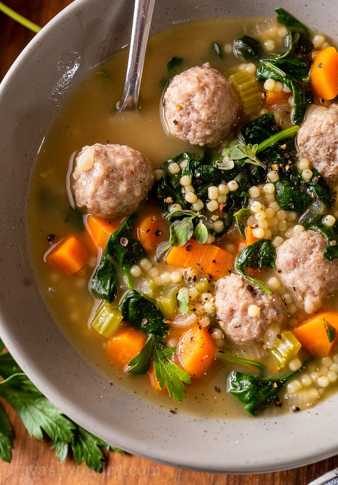 bowl of sausage italian soup with carrots and spinach