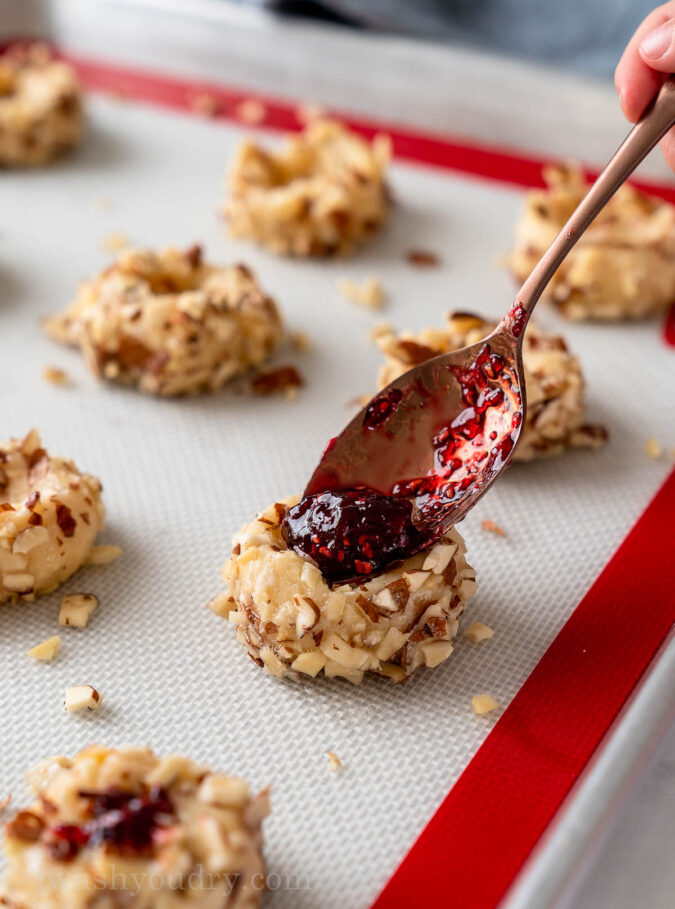 filling cookie with raspberry preserves and almonds
