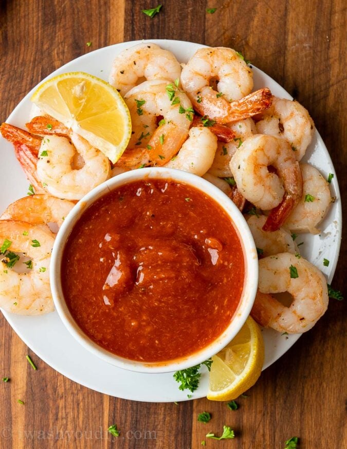 Plate of shrimp with lemon and cocktail sauce