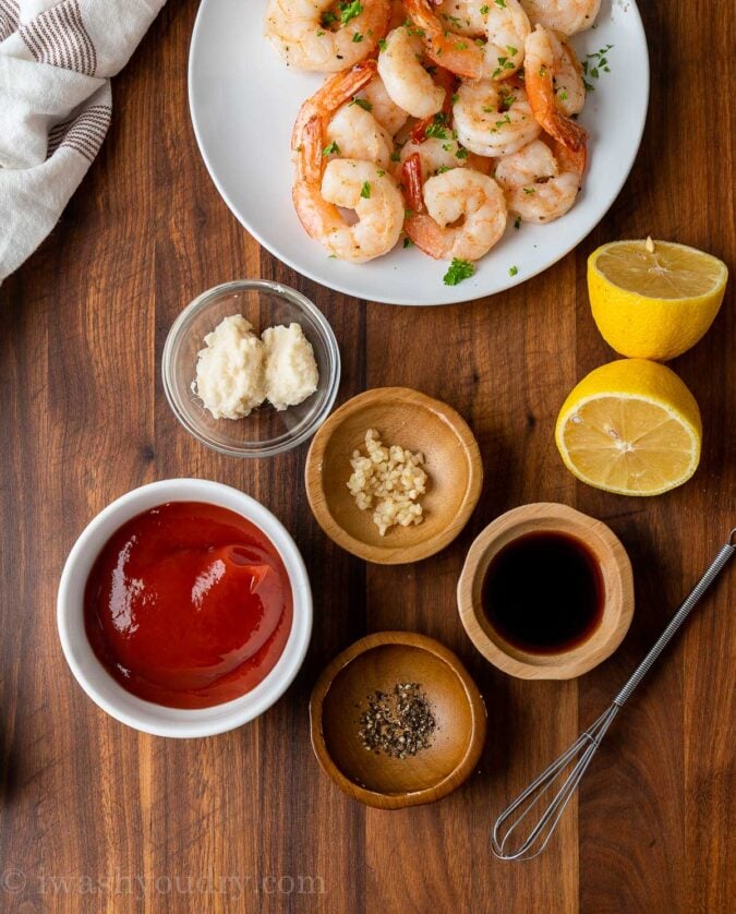 ingredients in cocktail sauce on wooden table with shrimp