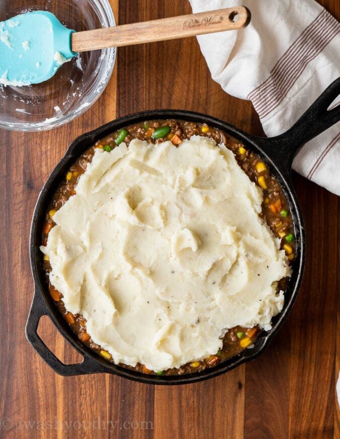 mashed potatoes on top of ground beef and gravy