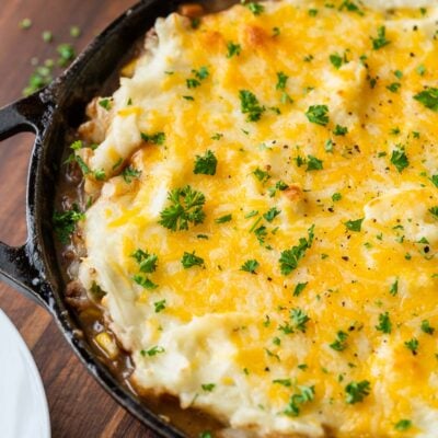 cast iron skillet with cottage pie and cheese