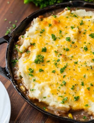 cast iron skillet with cottage pie and cheese